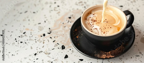 Pouring steamed milk into a...