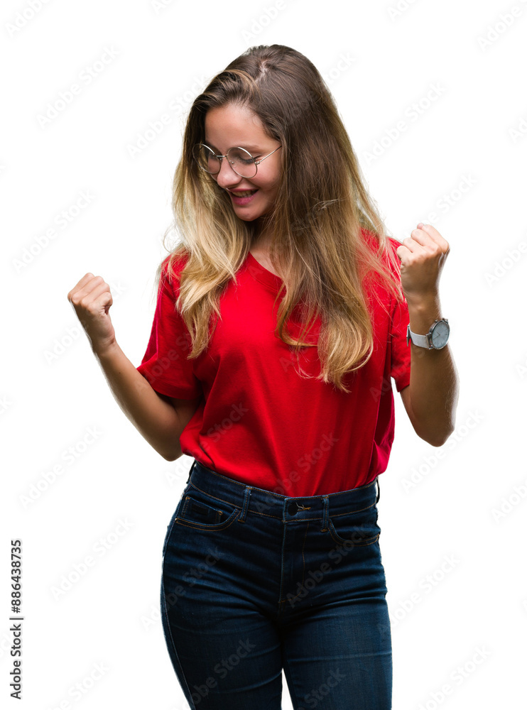 Young beautiful blonde woman wearing glasses over isolated background very happy and excited doing winner gesture with arms raised, smiling and screaming for success. Celebration concept. Young beautiful blonde woman wearing glasses over isolated background very happy and excited doing winner gesture with arms raised, smiling and screaming for success. Celebration concept.