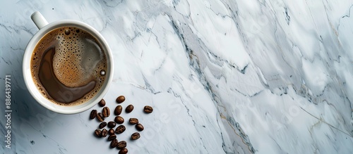 Coffee cup and beans on mar...
