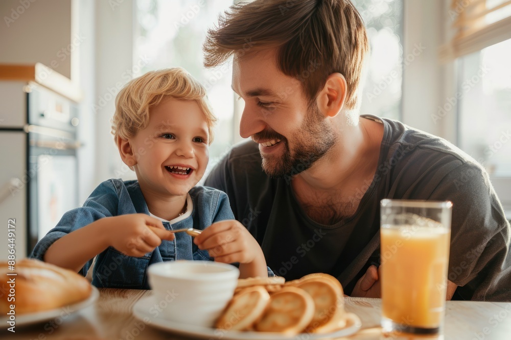 A happy father and son were having breakfast at home. A happy father and son were having breakfast at home.
