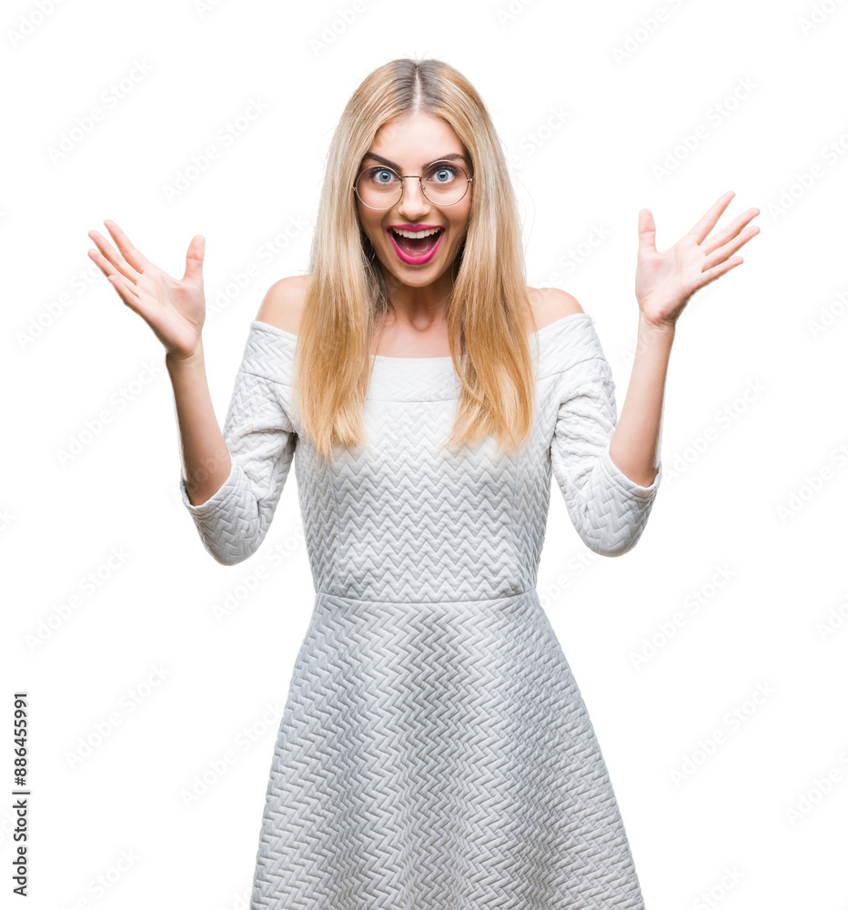 Young beautiful blonde woman wearing glasses over isolated background celebrating crazy and amazed for success with arms raised and open eyes screaming excited. Winner concept Young beautiful blonde woman wearing glasses over isolated background celebrating crazy and amazed for success with arms raised and open eyes screaming excited. Winner concept