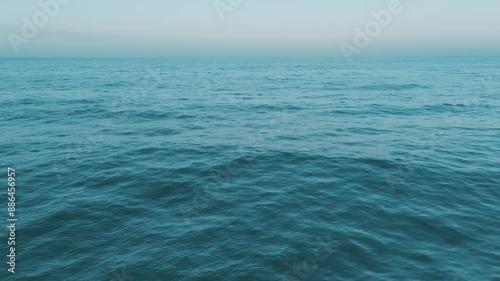 Wallpaper Mural A serene view of tranquil blue ocean waves under a clear sky at sunset, creating a peaceful scene in nature Torontodigital.ca