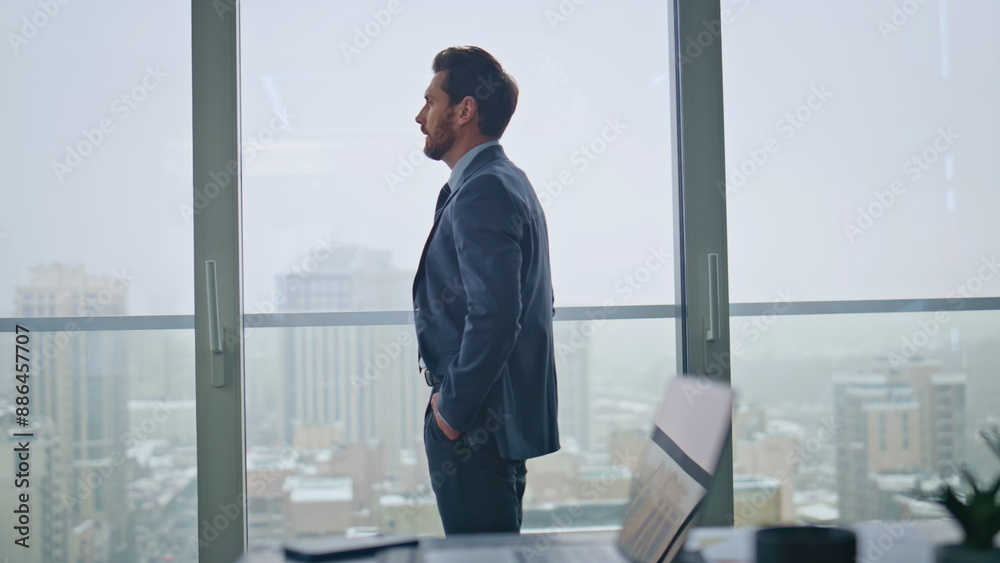 Nervous manager walking office room rear view. Pensive businessman looking city Nervous manager walking office room rear view. Pensive businessman looking city