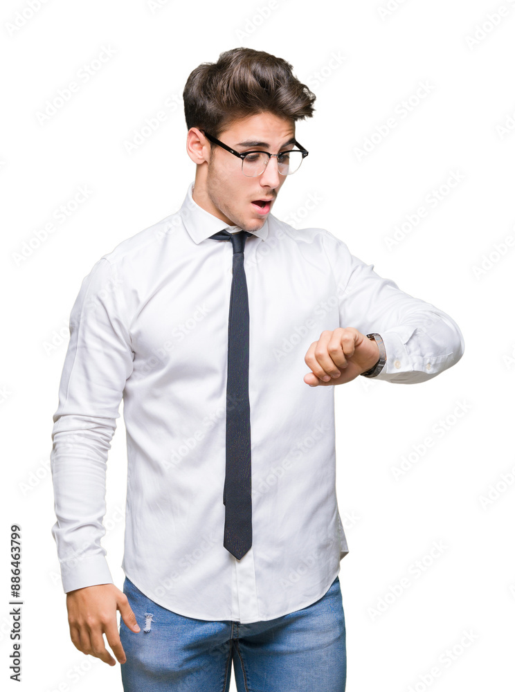 Young business man wearing glasses over isolated background Looking at the watch time worried, afraid of getting late Young business man wearing glasses over isolated background Looking at the watch time worried, afraid of getting late
