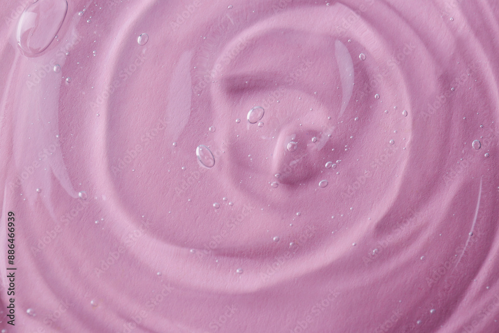 Sample of transparent shower gel on pink background, closeup Sample of transparent shower gel on pink background, closeup