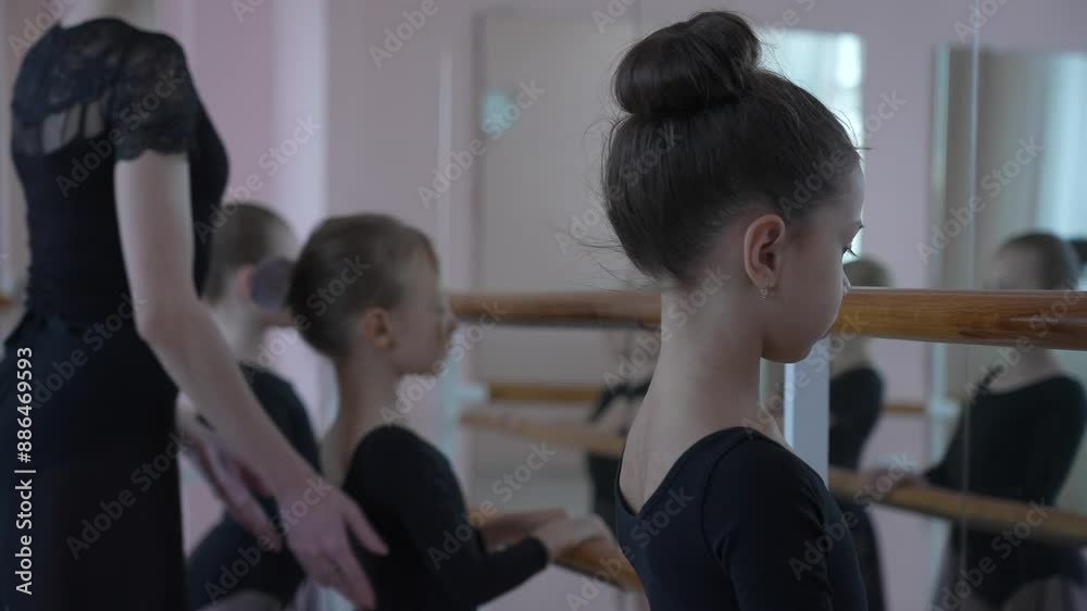 Children's ballet school. Caucasian woman teaching ballet to little girls. Children's ballet school. Caucasian woman teaching ballet to little girls.