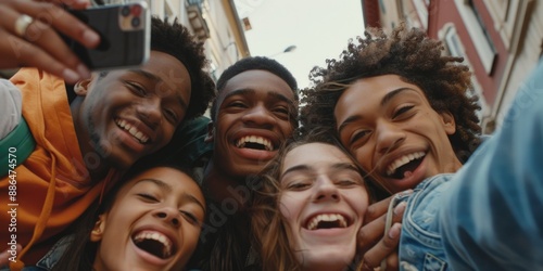 Friends smiling and taking a selfie together, useful for social media posts or advertising campaigns