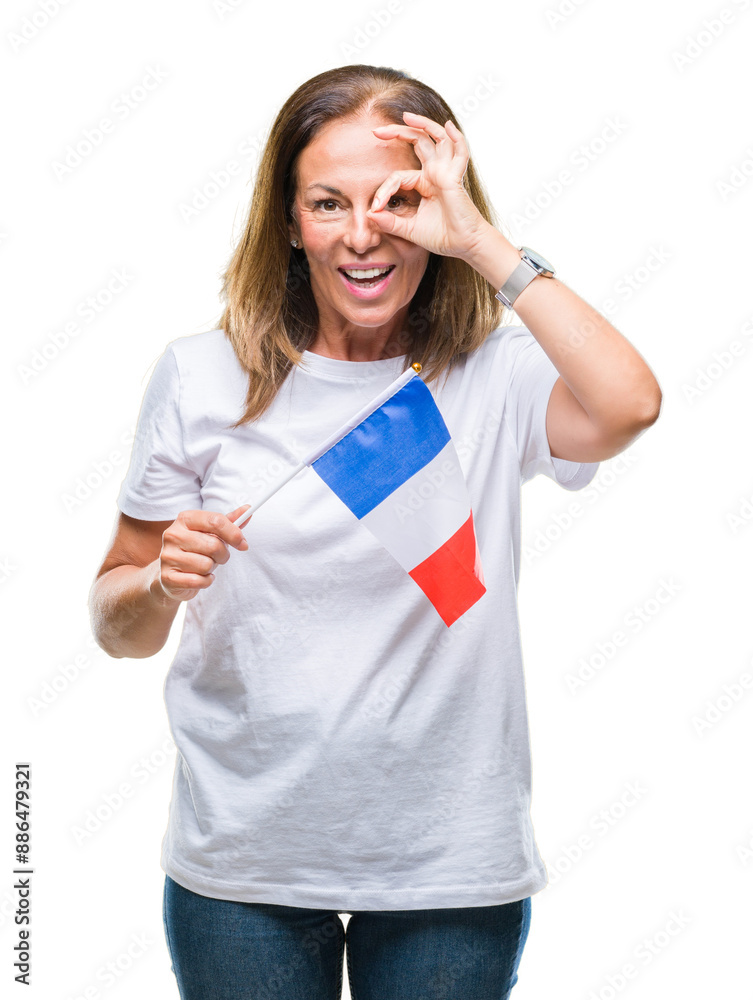 Middle age hispanic woman holding flag of France over isolated background with happy face smiling doing ok sign with hand on eye looking through fingers Middle age hispanic woman holding flag of France over isolated background with happy face smiling doing ok sign with hand on eye looking through fingers