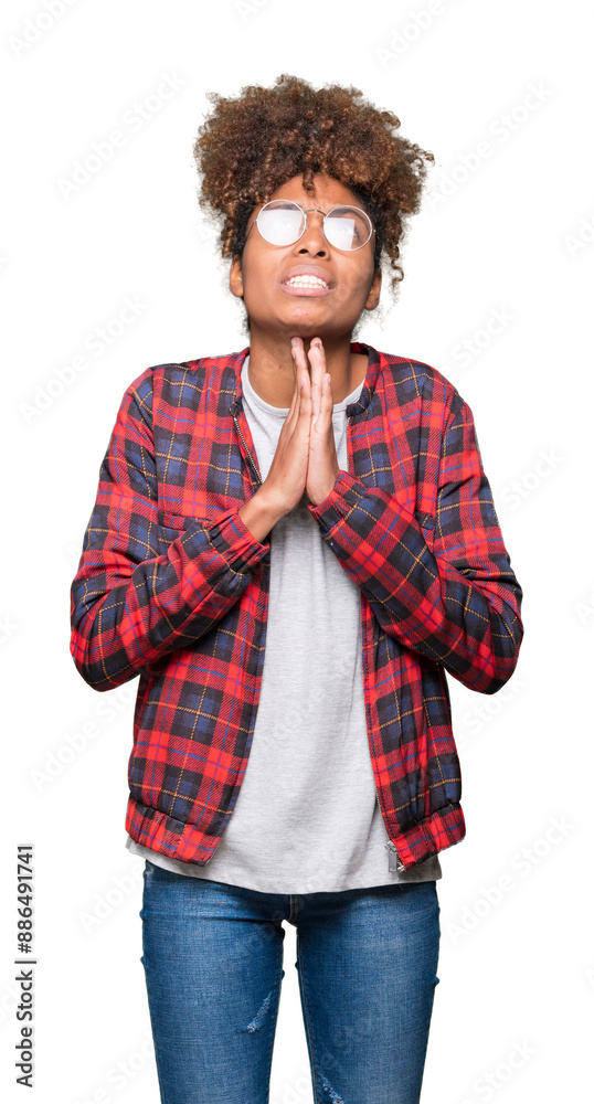 Beautiful young african american woman wearing glasses over isolated background begging and praying with hands together with hope expression on face very emotional and worried. Asking for forgiveness. Beautiful young african american woman wearing glasses over isolated background begging and praying with hands together with hope expression on face very emotional and worried. Asking for forgiveness.