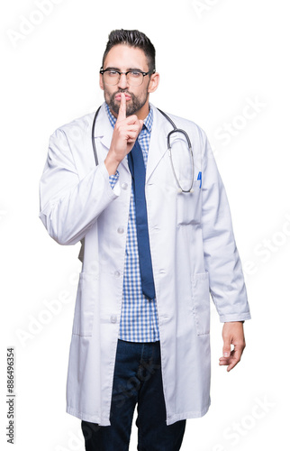 Handsome young doctor man over isolated background asking to be quiet with finger on lips. Silence and secret concept.