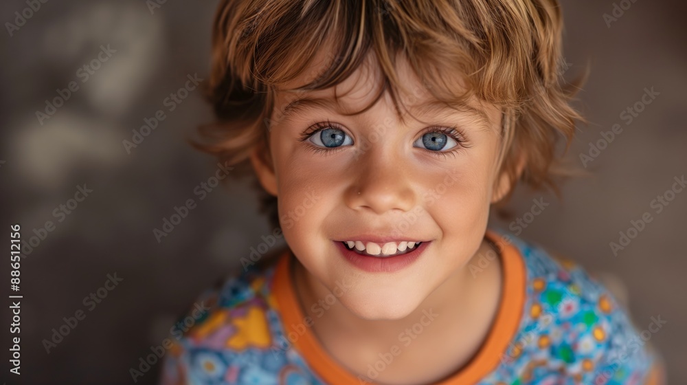 Joyful Young Boy with Light Brown Hair and Blue Eyes Smiling Upwards in Colorful Patterned Shirt, CloseUp Portrait for Family, Childhood, and Happiness Themes Joyful Young Boy with Light Brown Hair and Blue Eyes Smiling Upwards in Colorful Patterned Shirt, CloseUp Portrait for Family, Childhood, and Happiness Themes
