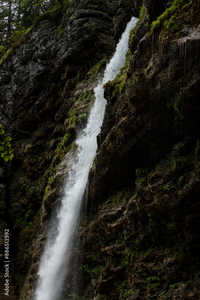 Perichnik waterfall is a beautiful drop from the mountain cliff, in Triglav National Park. Slovenian waterfall. Long for walking and trekking, enter inside the cave to admire it. Power and majesty. Perichnik waterfall is a beautiful drop from the mountain cliff, in Triglav National Park. Slovenian waterfall. Long for walking and trekking, enter inside the cave to admire it. Power and majesty.