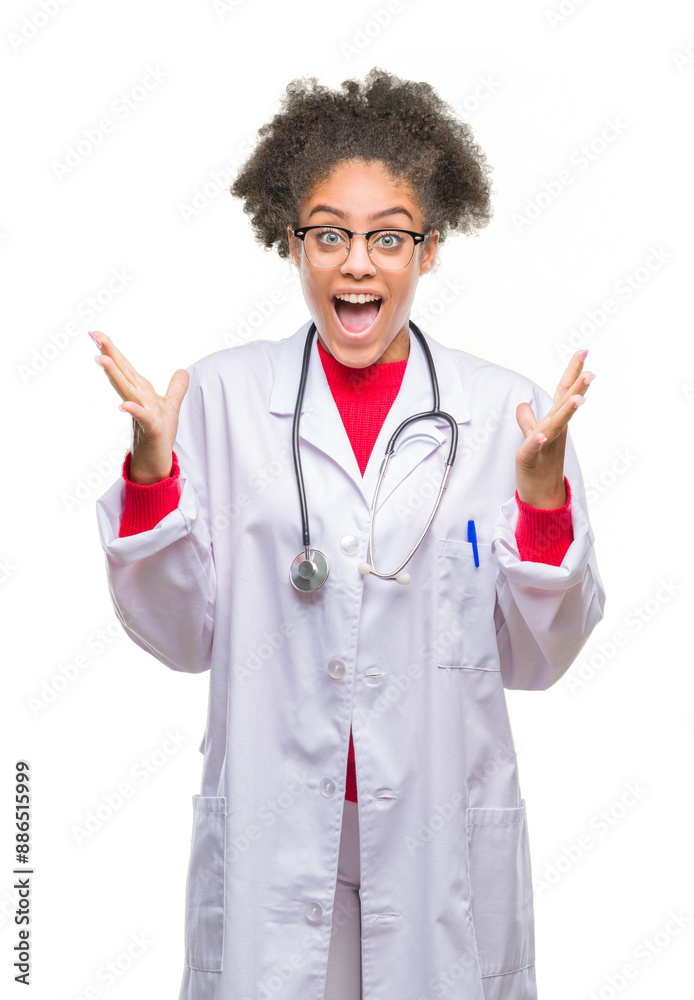 Young afro american doctor woman over isolated background celebrating crazy and amazed for success with arms raised and open eyes screaming excited. Winner concept Young afro american doctor woman over isolated background celebrating crazy and amazed for success with arms raised and open eyes screaming excited. Winner concept