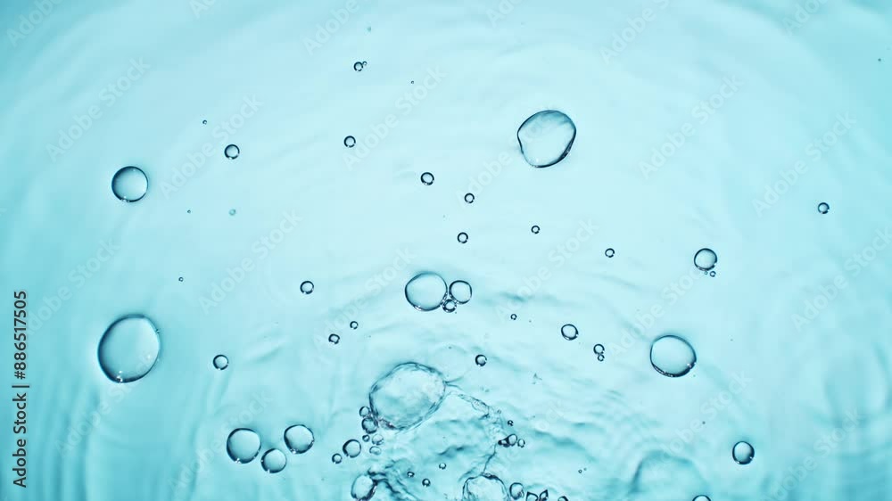 Slow motion of splashing water drops on on light blue background , filmed on high speed cinematic camera at 1000 FPS Slow motion of splashing water drops on on light blue background , filmed on high speed cinematic camera at 1000 FPS