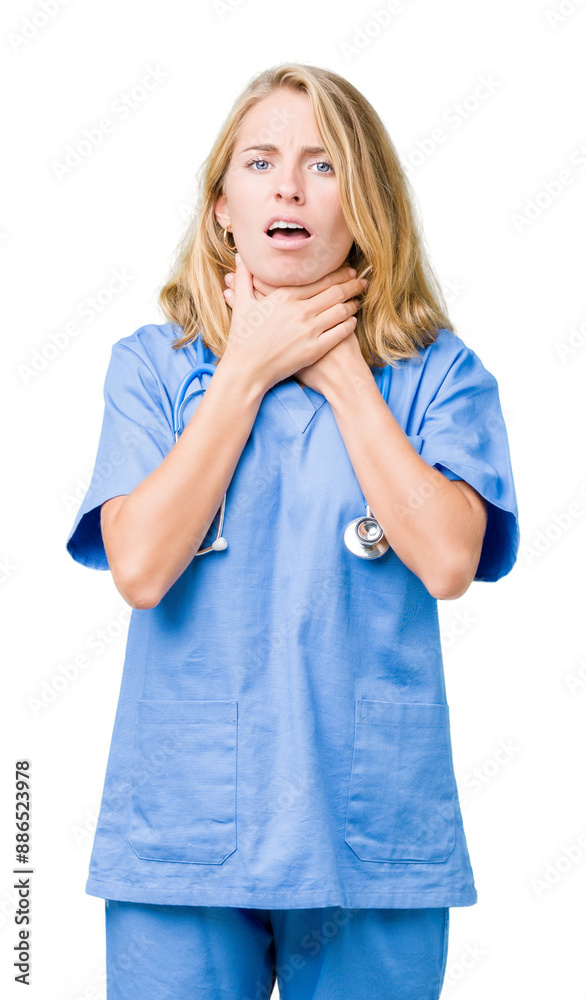 Beautiful young doctor woman wearing medical uniform over isolated background shouting and suffocate because painful strangle. Health problem. Asphyxiate and suicide concept.