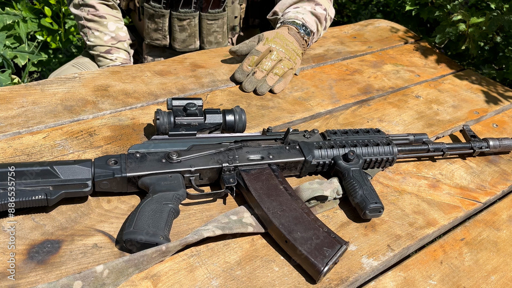 An Ak-74 Kalashnikov assault rifle with an optical sight lies on the ...