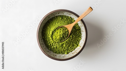 Wooden spoon with powdered matcha green tea in bowl, isolated on white. 