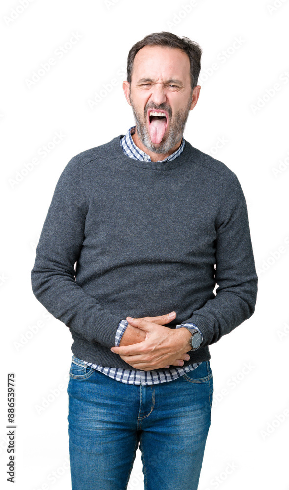 Fototapeta premium Handsome middle age senior man wearing a sweater over isolated background sticking tongue out happy with funny expression. Emotion concept.