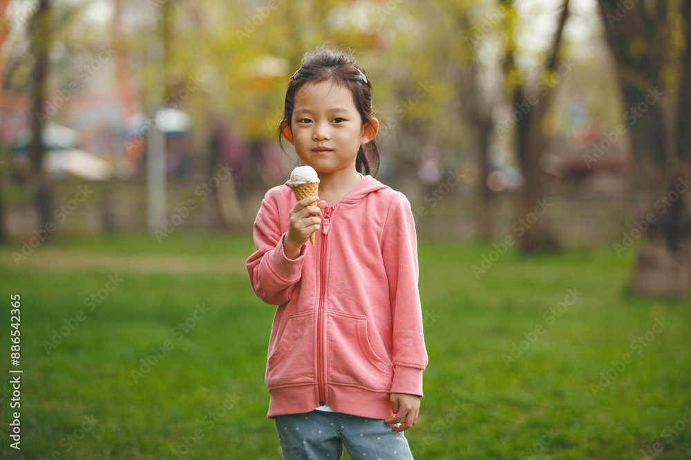 Little Girl Enjoying Ice Cream in Summer Park Little Girl Enjoying Ice Cream in Summer Park