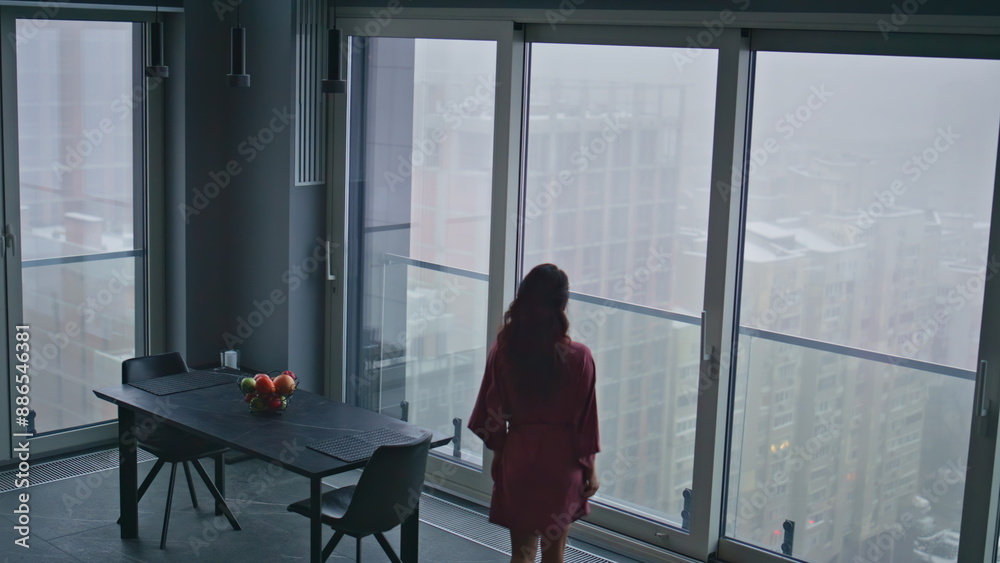 Relaxed model stepping kitchen looking window high angle view. Woman morning Relaxed model stepping kitchen looking window high angle view. Woman morning