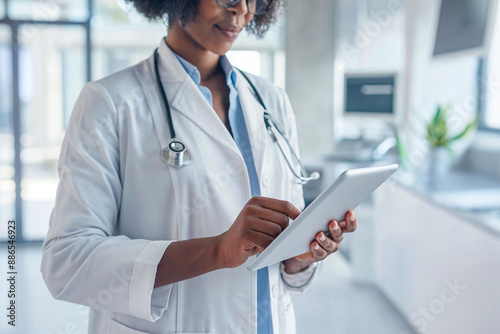 A black female doctor is looking at an ipad photo