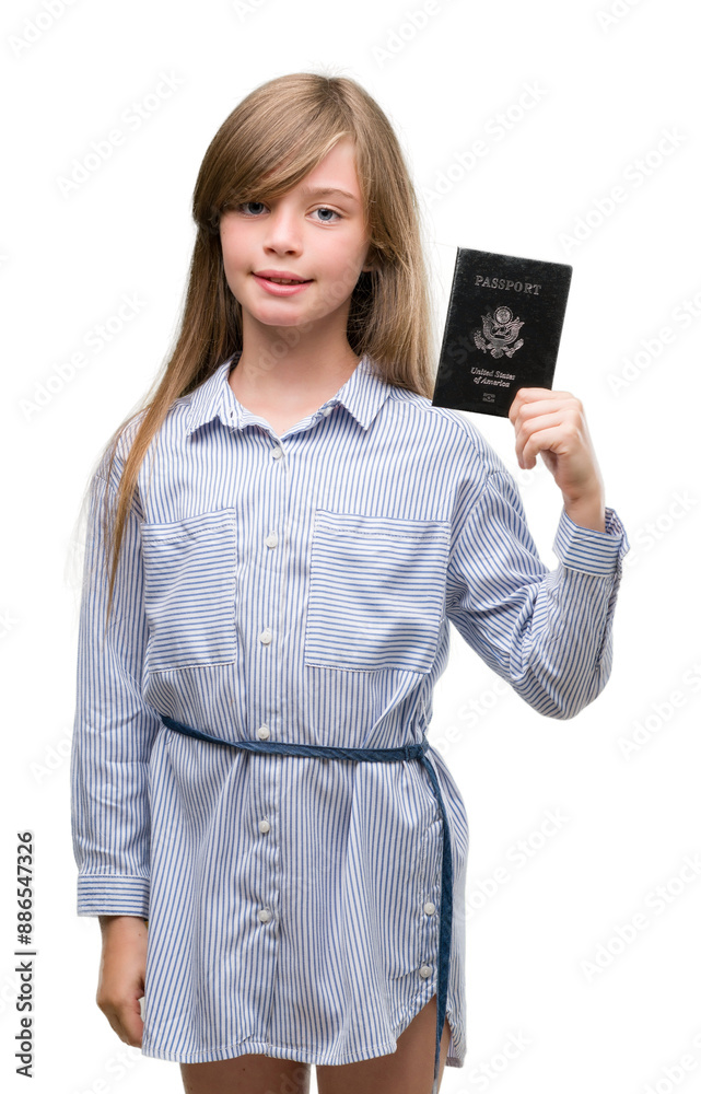 Young blonde toddler holding american passport with a happy face standing and smiling with a confident smile showing teeth Young blonde toddler holding american passport with a happy face standing and smiling with a confident smile showing teeth