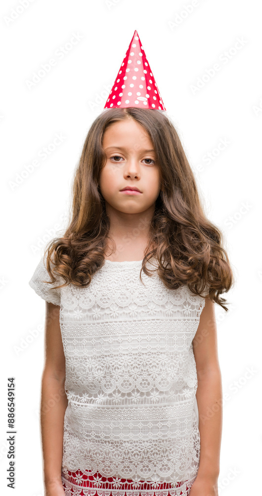 Brunette hispanic girl wearing birthday hat with a confident expression on smart face thinking serious Brunette hispanic girl wearing birthday hat with a confident expression on smart face thinking serious