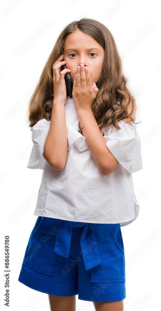 Brunette hispanic girl using smartphone cover mouth with hand shocked with shame for mistake, expression of fear, scared in silence, secret concept