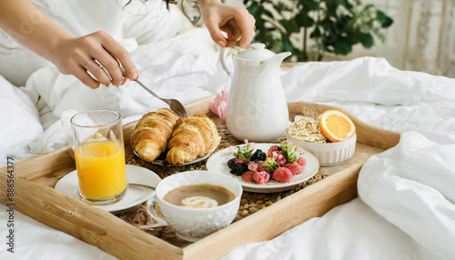 Traditional romantic breakfast in bed in white and beige bedroom