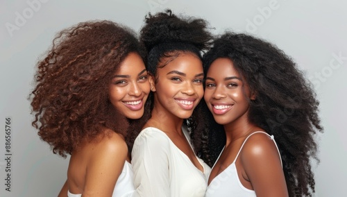 Young beautiful smiling diverse women friends with long salon styled hair posing together, healthy locks. isolated white background