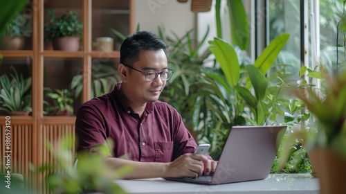 Man with Laptop in Green Office photo