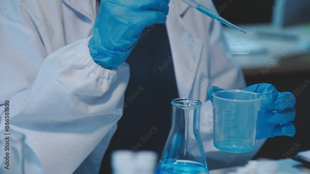 chemist,scientist hand dropping chemical liquid into test tube, science research and development concept chemist,scientist hand dropping chemical liquid into test tube, science research and development concept