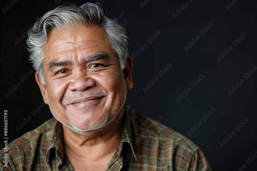 Close-up portrait of a middle aged Indigenous man, studio photo, against a sleek gray studio backdrop Close-up portrait of a middle aged Indigenous man, studio photo, against a sleek gray studio backdrop