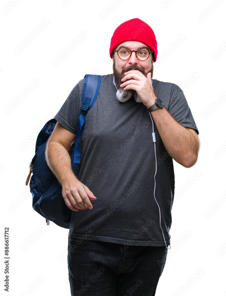Naklejka premium Young hipster man wearing red wool cap and backpack over isolated background looking stressed and nervous with hands on mouth biting nails. Anxiety problem.