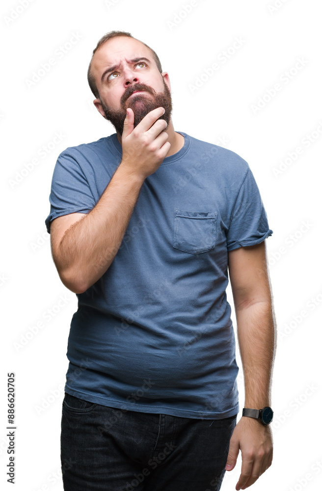 Young caucasian hipster man over isolated background with hand on chin thinking about question, pensive expression. Smiling with thoughtful face. Doubt concept. Young caucasian hipster man over isolated background with hand on chin thinking about question, pensive expression. Smiling with thoughtful face. Doubt concept.