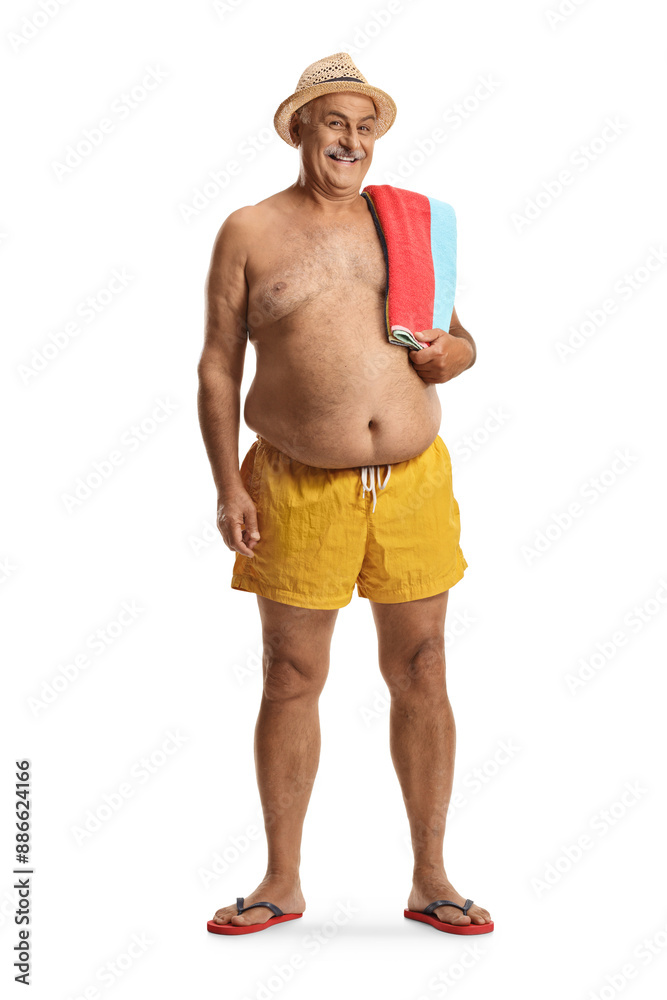 Mature man in swimming shorts holding a towel