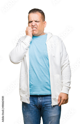 Middle age arab man wearing sweatshirt over isolated background looking stressed and nervous with hands on mouth biting nails. Anxiety problem.