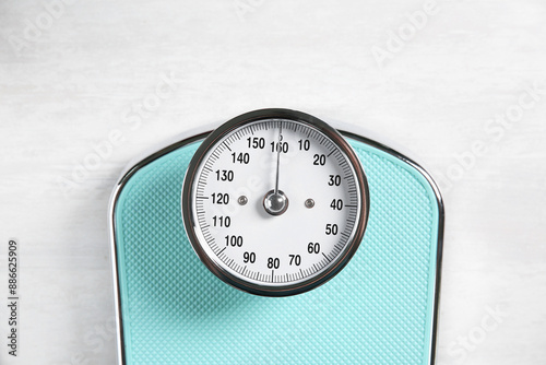Cuadro en lienzo One bathroom scale on white wooden background, top view