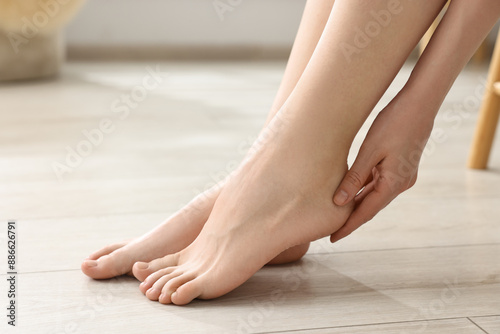 Closeup view of woman`s groomed feet after care procedure on floor
