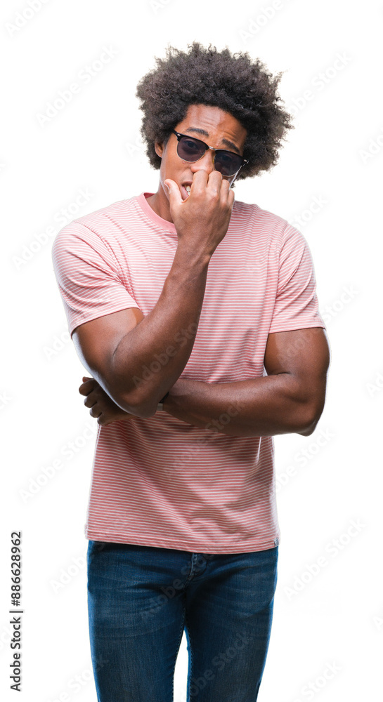 Afro american man wearing sunglasses over isolated background looking stressed and nervous with hands on mouth biting nails. Anxiety problem. Afro american man wearing sunglasses over isolated background looking stressed and nervous with hands on mouth biting nails. Anxiety problem.