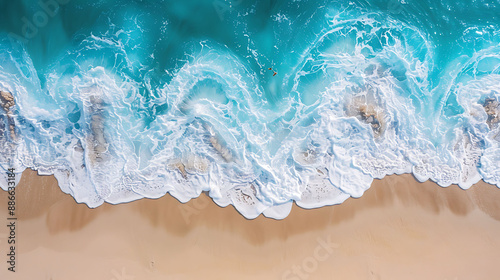 Aerial view of turquoise ocean waves crashing on sandy beach © Maule