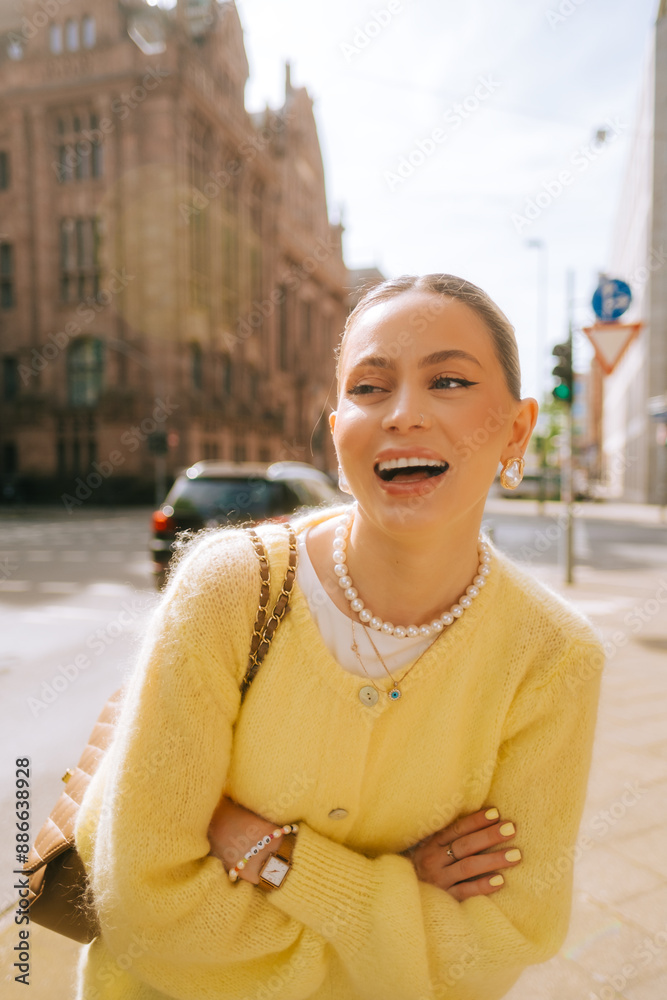 Portrait of young attractive woman fashion model posing outdoor at city street .