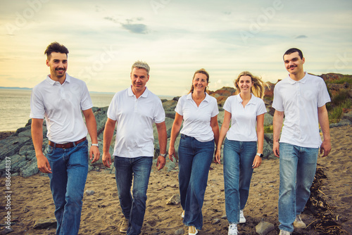 big family at beach on summer time, relax and support. Sunset, nature and smile with parents, kids walking by the sea for vacation