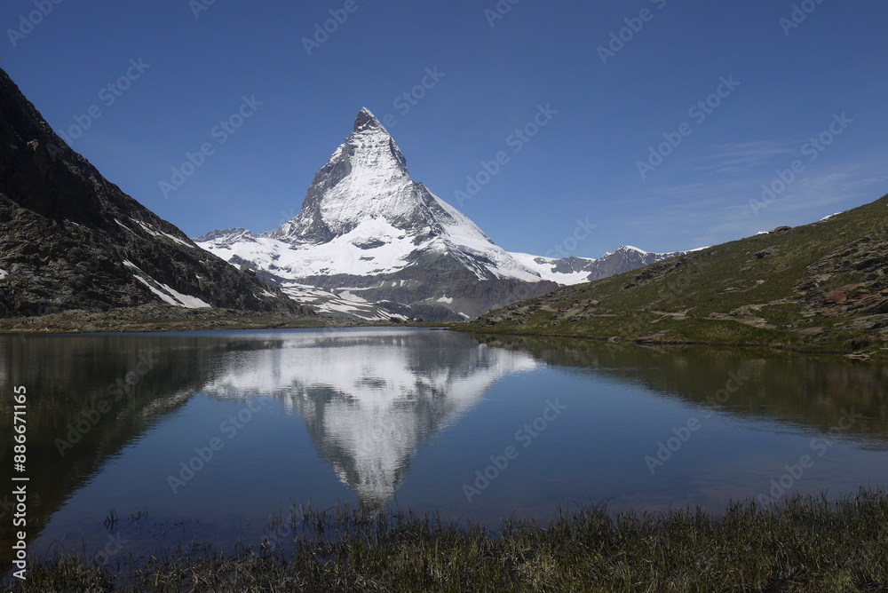 Naklejka premium the reflection of the Matterhorn mountain on the surface of Riffelsee in the summer, Switzerland