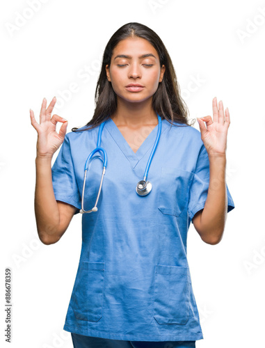 Young arab doctor surgeon woman over isolated background relax and smiling with eyes closed doing meditation gesture with fingers. Yoga concept.