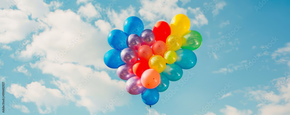 A cheerful background of rainbow balloons arranged in the shape of a heart, floating gently against A cheerful background of rainbow balloons arranged in the shape of a heart, floating gently against