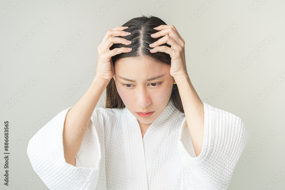 Damaged Hair symptom, face serious asian young woman, girl worry about balding, looking at scalp in mirror, hand in break into front hair loss, thin problem. Health care treatment for beauty concept. Damaged Hair symptom, face serious asian young woman, girl worry about balding, looking at scalp in mirror, hand in break into front hair loss, thin problem. Health care treatment for beauty concept.
