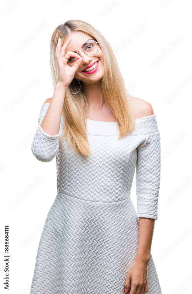 Young beautiful blonde woman wearing glasses over isolated background doing ok gesture with hand smiling, eye looking through fingers with happy face. Young beautiful blonde woman wearing glasses over isolated background doing ok gesture with hand smiling, eye looking through fingers with happy face.