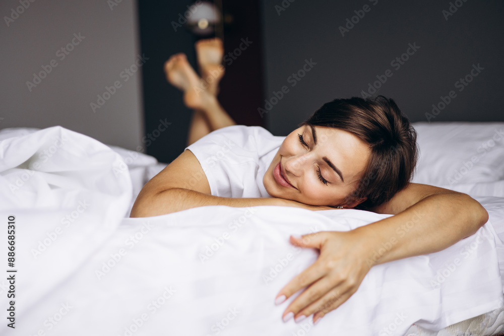 Woman lying in her bed at home and smiling Woman lying in her bed at home and smiling