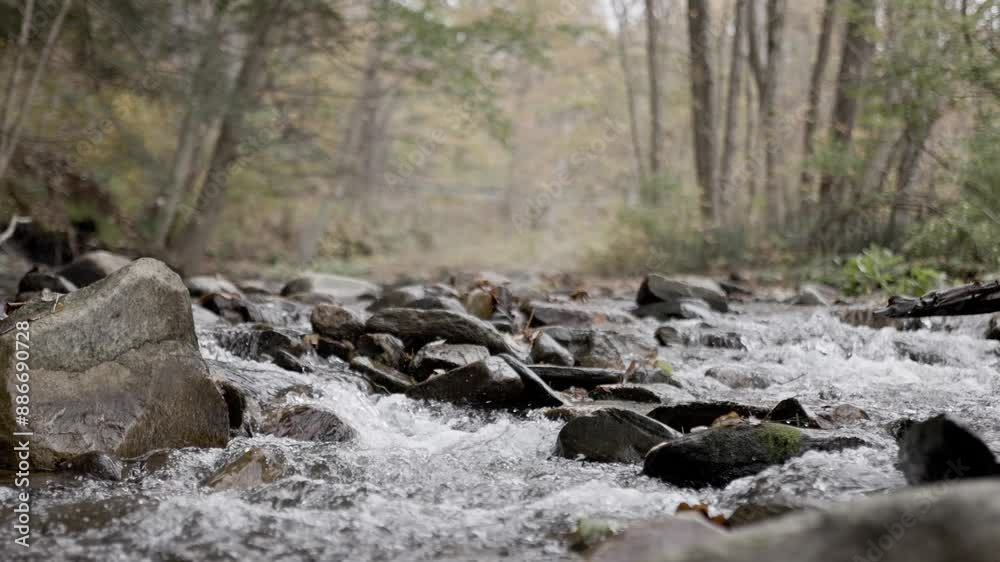 4k slow motion video of running water over a stream rock with great texture. 4k slow motion video of running water over a stream rock with great texture.